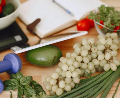 A vibrant composition of fruits, vegetables, and fitness items promoting a healthy lifestyle.